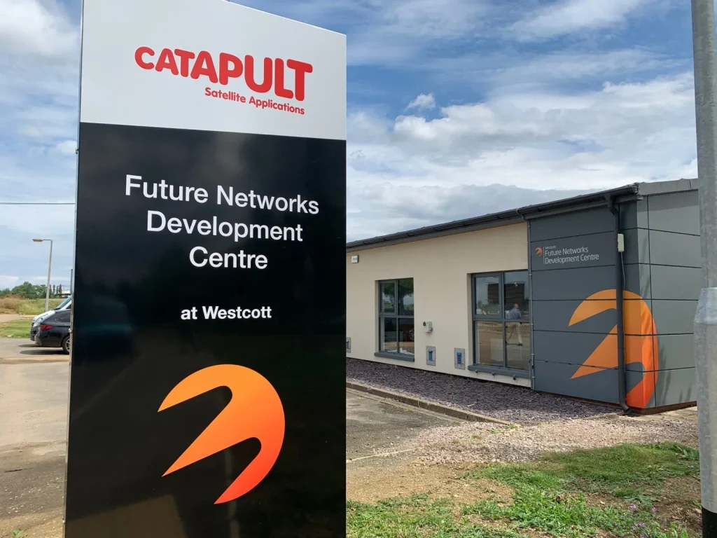 Sign for Future Networks Development Centre at Westcott outside a modern building with a logo and clear sky.