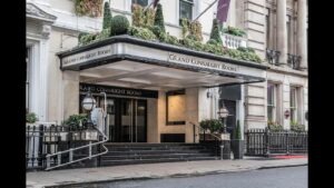 Entrance of the Grand Connaught Rooms with steps and hanging plants, featuring elegant lighting and signage.