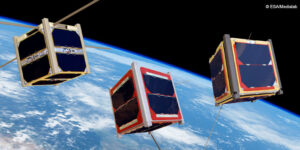 Three cube satellites orbit above the Earth against the backdrop of space.