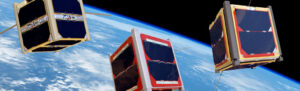 Three cube satellites orbiting Earth, with blue and white planet surface visible in the background.
