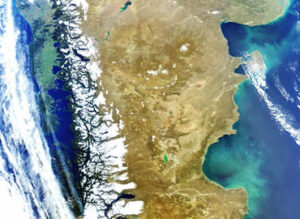 Satellite view of South America's southern region, showing mountains, forests, oceans, and varying terrain.