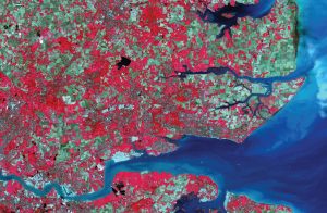 Satellite view of a landscape with red and green colors, titled "Geospatial Innovation in 2020.