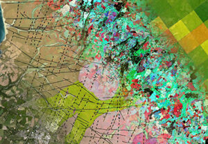 A colorful satellite image with patterns in green, pink, and blue, overlayed with black grid lines.