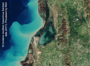 Satellite view of coastal area with turquoise water and green land. © Copernicus Sentinel/ESA 2017.