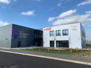 Modern buildings of the Westcott Innovation Centre and Catapult with clear skies in the background.