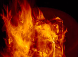 Bright orange and yellow flames in a dark background, showcasing intense fire.