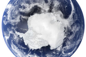 View of Earth from space highlighting Antarctica surrounded by clouds and ocean.