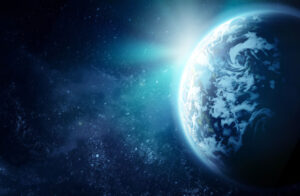 Earth from space, partially illuminated by sunlight, with a starry background.