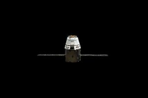 Space capsule floating in a black background.