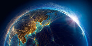 A view of Earth from space showing illuminated connections and networks across Asia and the Pacific, with the sun rising.