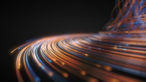 Abstract image of glowing orange and blue fiber optic strands against a dark background, creating a dynamic wave effect.