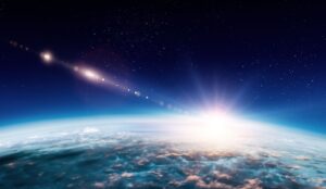 Sunrise over Earth from space, with a bright sun and a starry sky, illuminating the planet's atmosphere and clouds.