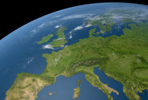 Satellite view of Europe showing green landmasses and surrounding blue ocean under clear skies.