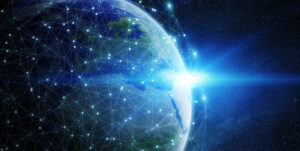 Earth with a digital network overlay and bright light on the horizon, set against a starry space background.