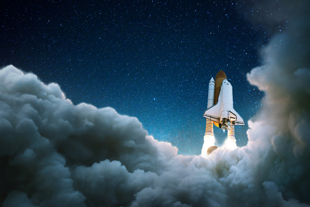 Space shuttle launching into starry night sky with billowing clouds below.
