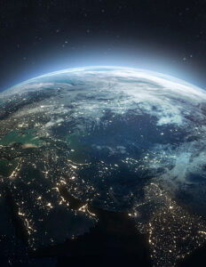 Earth from space with city lights across continents under a starry sky.