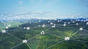 Digital icons connected over a lush green landscape, symbolizing technology integration with nature.