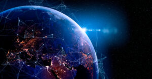 A digital rendering of Earth from space, highlighting illuminated city networks with a bright sunburst effect.