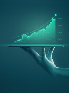 A hand holds a tablet projecting a glowing upward-trending stock chart in a dark, teal-hued setting.