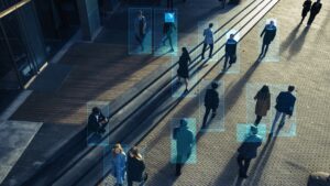 Aerial view of people walking on a street, each enclosed in a digital blue rectangle.