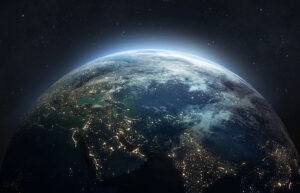 View of Earth from space showcasing city lights and a glowing atmosphere against a backdrop of stars.