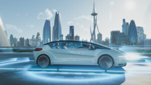 Futuristic white car driving on elevated road with a modern city skyline in the background.