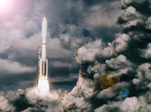 A rocket launches into the cloudy sky with bright exhaust flames and smoke trailing behind.