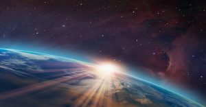 Sunrise over Earth from space with light rays, a starry sky, and a nebula in the background.