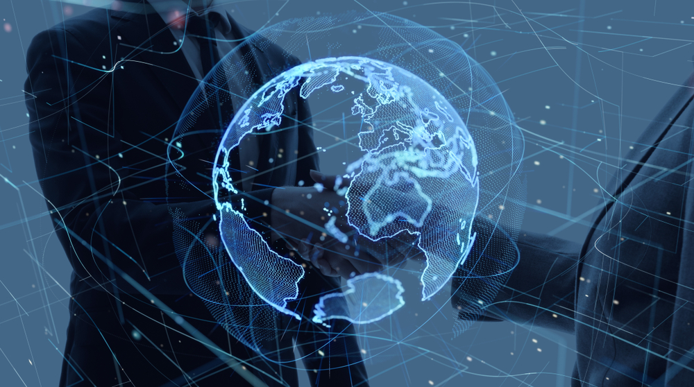 Two people in suits shaking hands, with a digital globe and network lines overlaying the image.