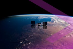 A satellite orbits above Earth’s surface with land, ocean, and clouds visible below, crossed by a purple band.