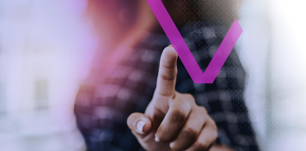 A person touches a floating purple checkmark on a digital screen with a blurred background.
