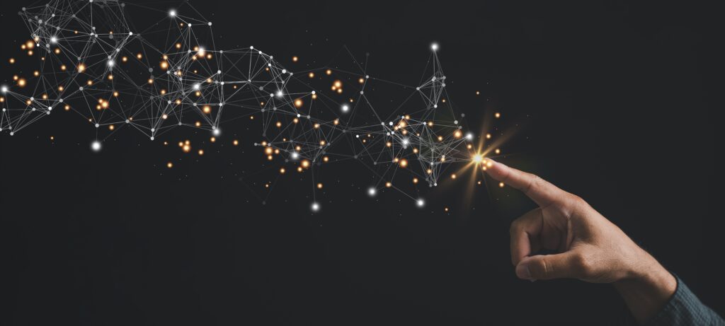 A hand touches glowing digital nodes and connections on a dark background, symbolizing technology and innovation.