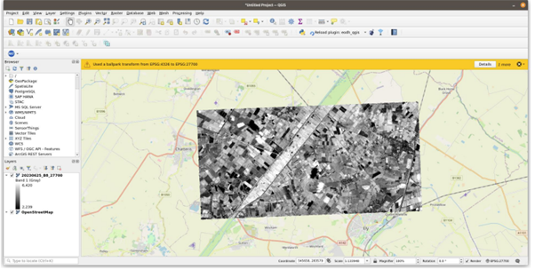 A grayscale satellite image overlay on a map in the QGIS software interface.