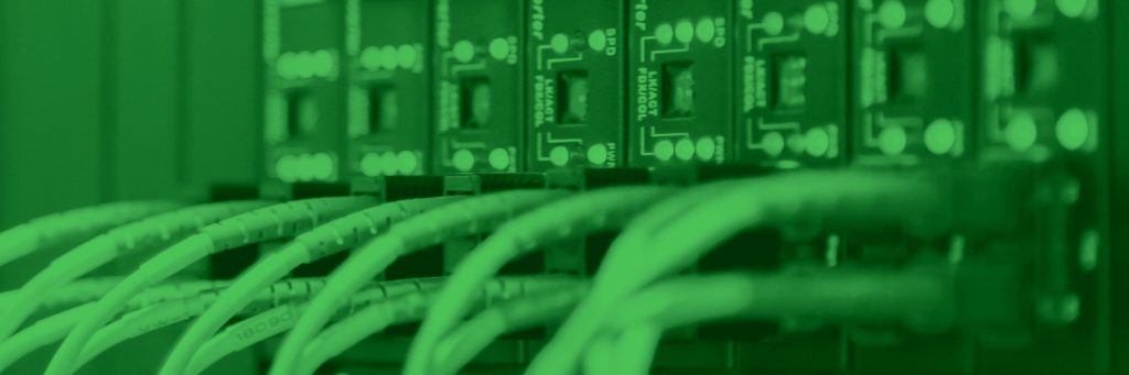 Close-up of network cables connected to server ports, with a green color filter over the image.