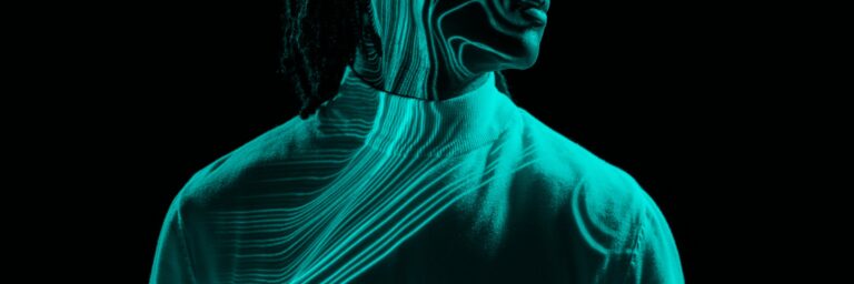 Silhouette of a person with glowing turquoise lines tracing patterns over their face and clothing on a black background.