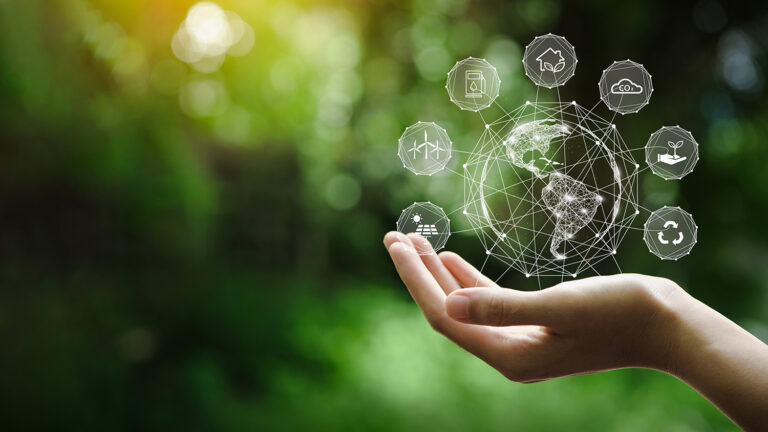A hand holds a digital globe with eco-friendly icons, symbolizing sustainability and environmental care.