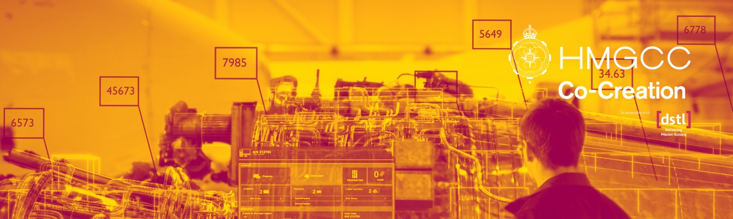 Person viewing digital schematics and data overlays in an industrial or engineering environment, labeled "HMGCC Co-Creation.