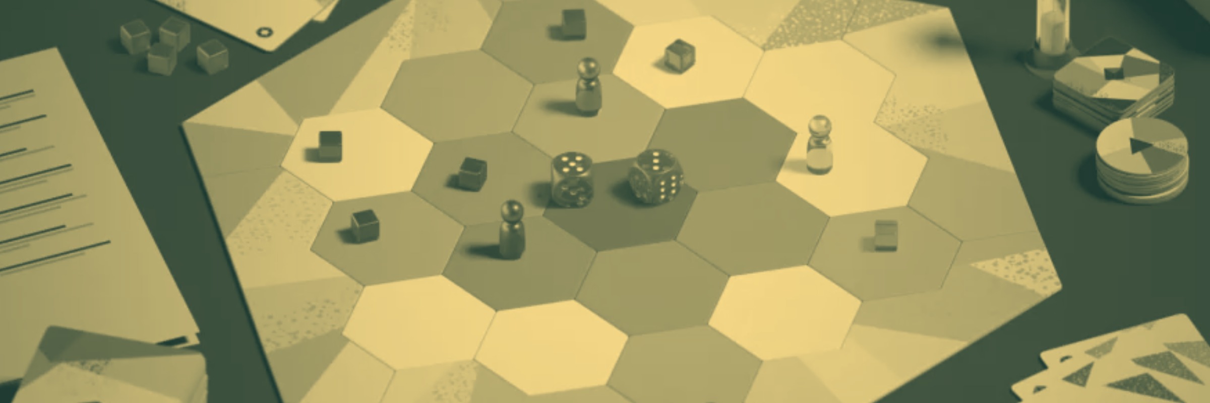Hexagonal board game with dice, pawns, cubes, cards, and chips arranged on a tabletop.