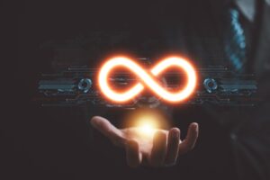 A glowing infinity symbol hovers above an outstretched hand in a dark, tech-themed setting.