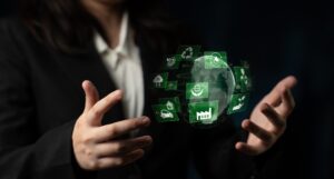 Person in a suit with hands around floating eco-friendly icons and a digital globe on a dark background.