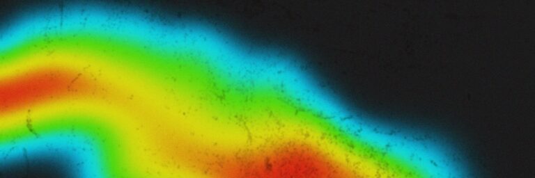 A colorful heat map gradient with blue, green, yellow, and red on a black background.