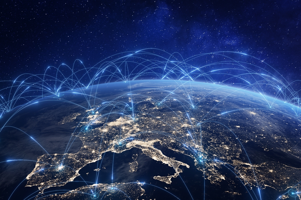 View of Europe from space at night with glowing network lines connecting major cities across the continent.