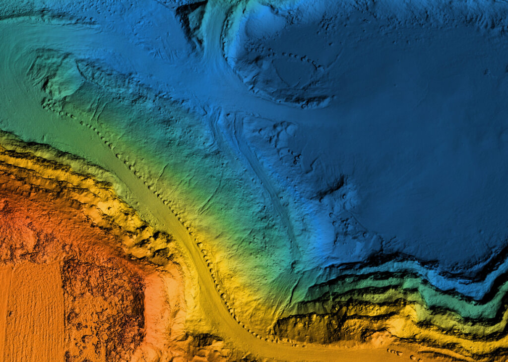 Colorful topographic map showing terrain elevations, with blues for low areas and oranges for higher ground.